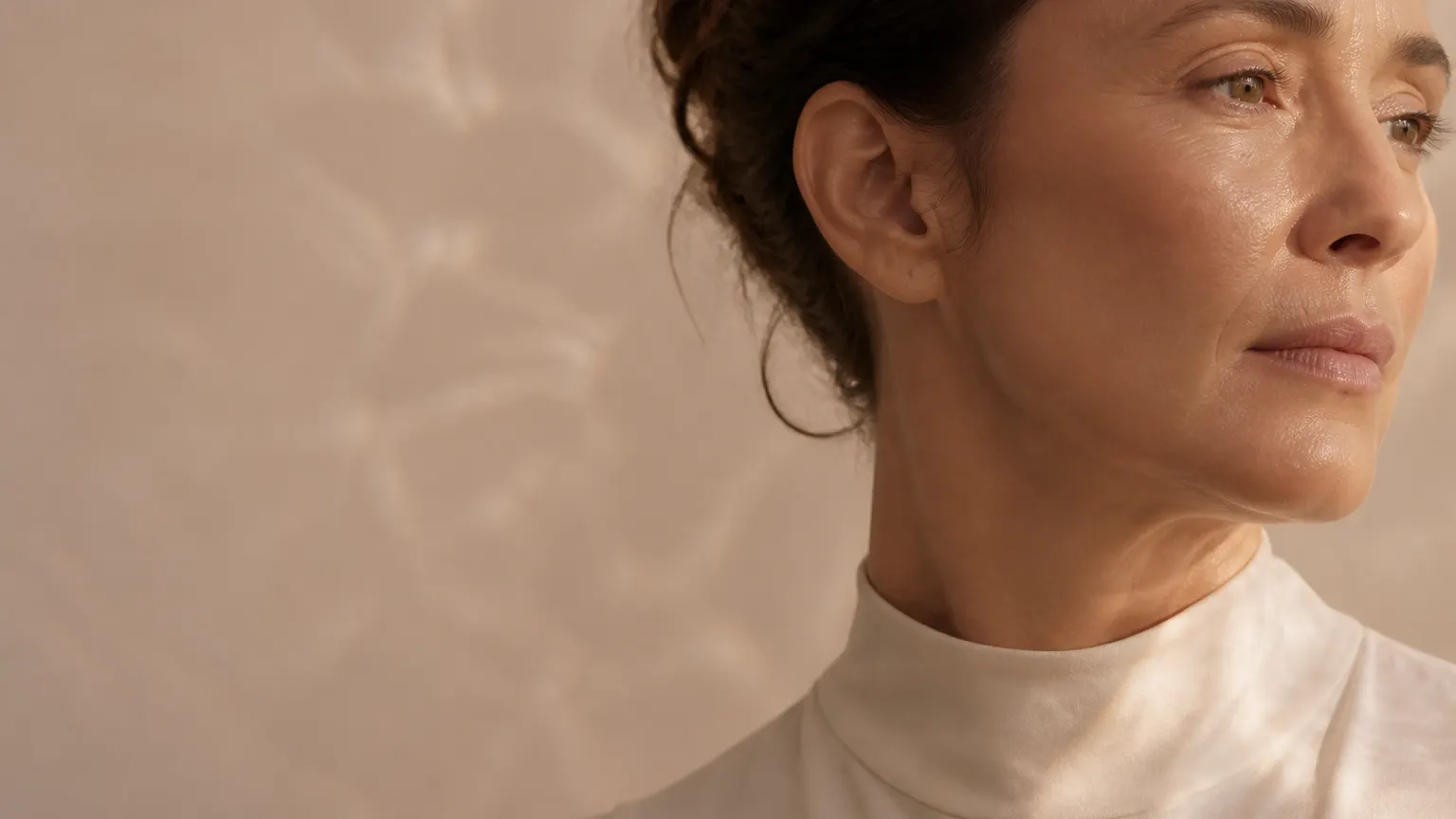 Close portrait of an adult woman in warm natural light.